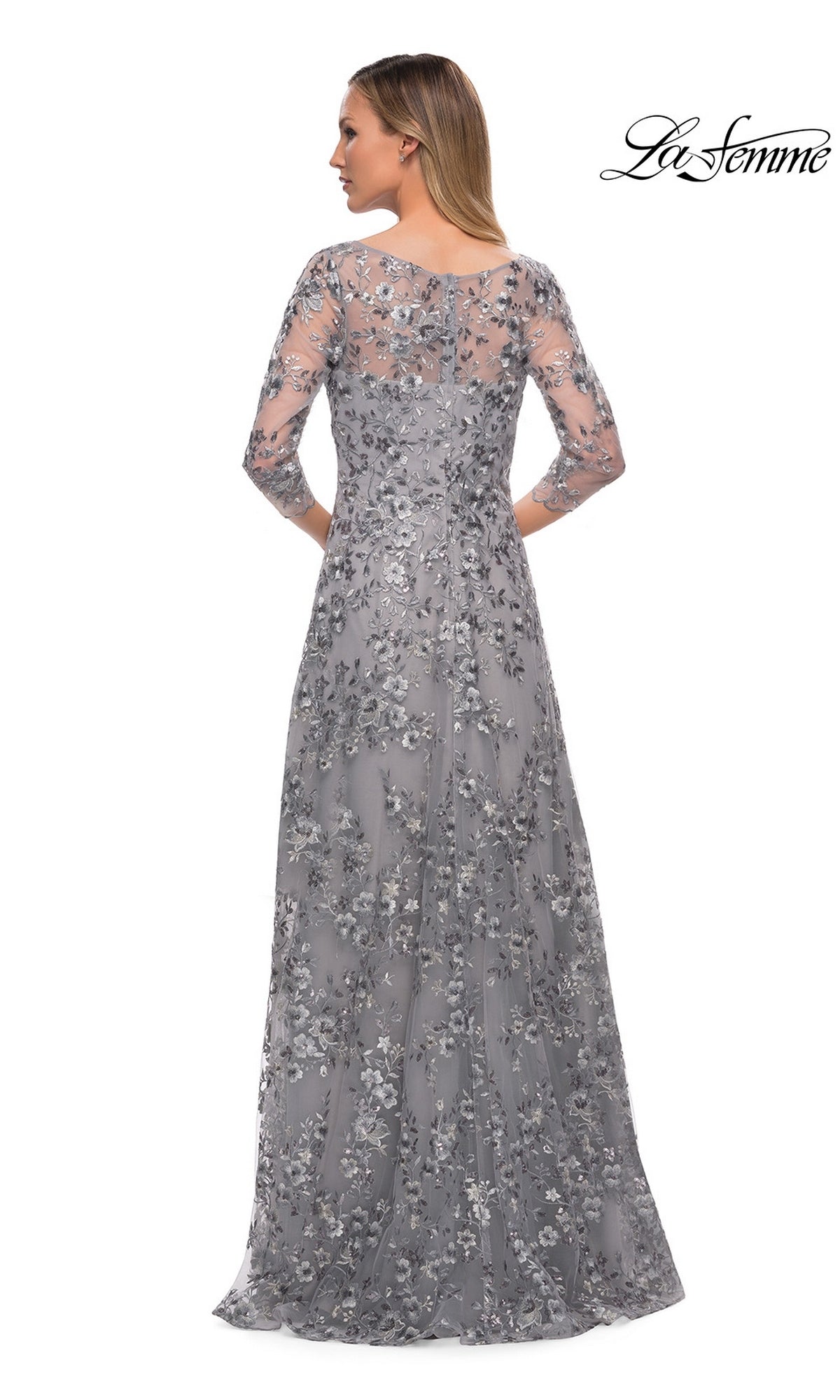 Woman elegantly shown from the back in Long Formal Dress: La Femme 29903, featuring silver metallic floral lace and sheer three-quarter sleeves.